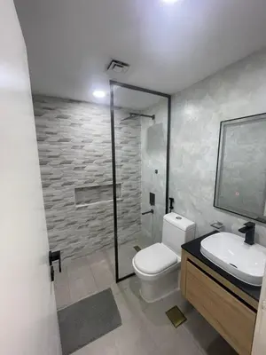 a bathroom with a toilet and a sink and a shower at Diamond Tower Marina Apartment in Dubai