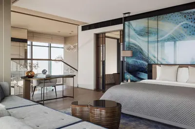 a bedroom with a bed and a table and a desk at One&Only One Za'abeel in Dubai