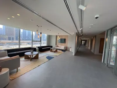 a living room with couches and tables in a building at 3BR facing Dubai Mall 5 min walk to Burj Khalifa in Dubai