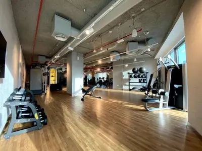 a gym with treadmills and chairs in a room at 3BR facing Dubai Mall 5 min walk to Burj Khalifa in Dubai