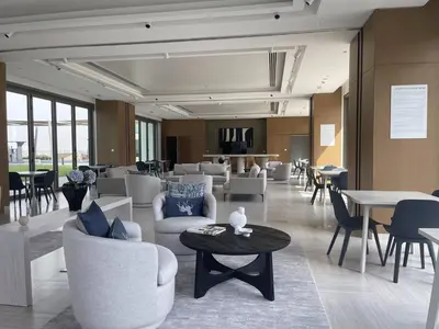 a lobby with couches and chairs and tables and a table at 3BR facing Dubai Mall 5 min walk to Burj Khalifa in Dubai