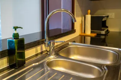 a kitchen sink with a faucet in a kitchen at Bellavista - High Floor - 1BR 29 Boulevard - Burj Khalifa & Fountain View in Dubai