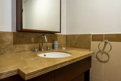 a bathroom counter with a sink and a mirror at Bellavista - High Floor - 1BR 29 Boulevard - Burj Khalifa & Fountain View in Dubai