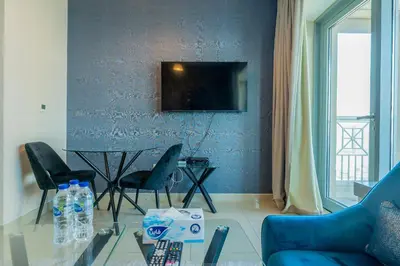 a living room with a couch and a table with chairs at Bellavista - High Floor - 1BR 29 Boulevard - Burj Khalifa & Fountain View in Dubai