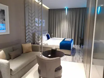 a hotel room with a bed and a couch at Canal View, Luxurious Studio In Downtown Dubai in Dubai