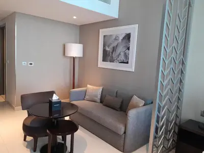 a living room with a couch and a table at Canal View, Luxurious Studio In Downtown Dubai in Dubai