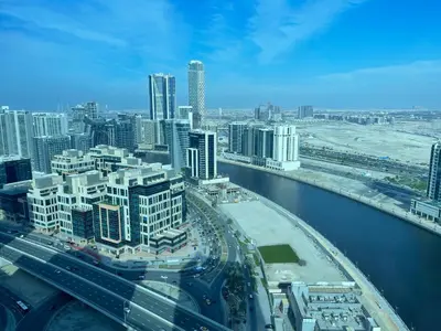 an aerial view of a city with a river and buildings at Canal View, Luxurious Studio In Downtown Dubai in Dubai