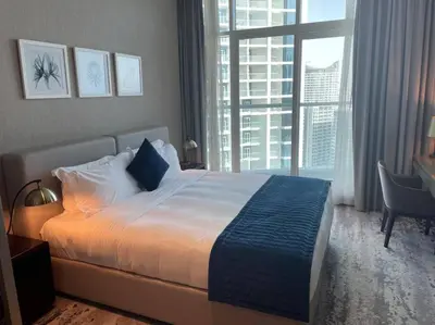 a bedroom with a large bed and a large window at Canal View, Luxurious Studio In Downtown Dubai in Dubai