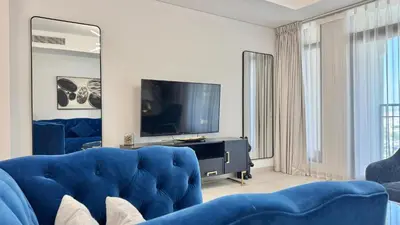 a living room with a blue couch and a tv at Spacious 2 bedroom in Madinat Jumeirah Living in Dubai