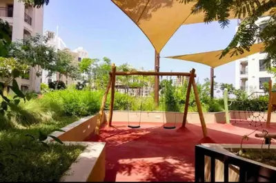 a playground with a swing set in a park at Spacious 2 bedroom in Madinat Jumeirah Living in Dubai