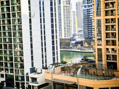a view of a body of water between tall buildings at La Buena Vida Holiday Homes - Deluxe, very spacious 5 Bedroom plus maidroom in Best location of JBR, Near to Beach, Marina and Tram station in Dubai