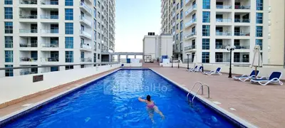 a woman swimming in a swimming pool in a building at 50% OFF Summer Offert, Nice w/ Balcony & Pool View in Dubai
