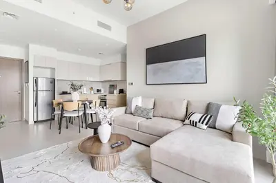 a living room with a couch and a table at Silkhaus in Burj Royale, stunning 1BR in Downtown premium tower in Dubai