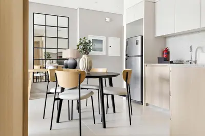 a kitchen and dining room with a table and chairs at Silkhaus in Burj Royale, stunning 1BR in Downtown premium tower in Dubai