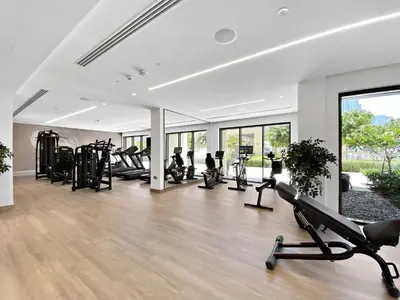 a gym with several treadmills and elliptical machines at Silkhaus sophisticated 1BDR in Downtown premium tower in Dubai