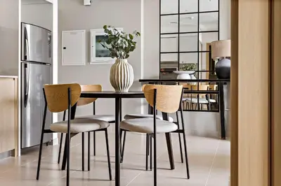 a dining room table with chairs and a vase on it at Silkhaus sophisticated 1BDR in Downtown premium tower in Dubai