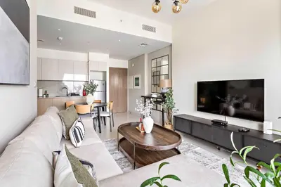 a living room with a couch and a table at Silkhaus sophisticated 1BDR in Downtown premium tower in Dubai