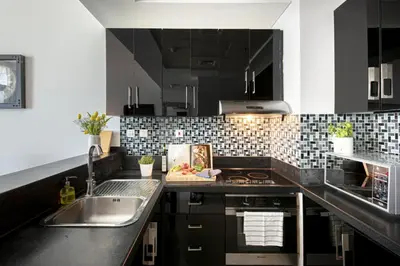 a kitchen with a sink and a counter top at Nasma Luxury Stays - Marina-View Oasis With Balcony Steps From The Sea in Dubai