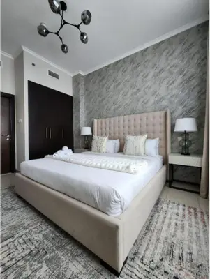 a bedroom with a large white bed in a room at Nasma Luxury Stays - Marina-View Oasis With Balcony Steps From The Sea in Dubai