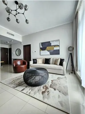 a living room with a couch and a ball on the floor at Nasma Luxury Stays - Marina-View Oasis With Balcony Steps From The Sea in Dubai