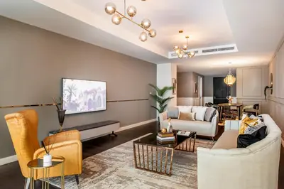 a living room with a couch and chairs at Nasma Luxury Stays - Limestone House in Dubai