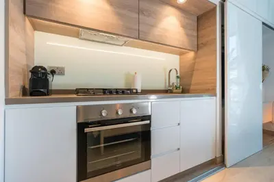 a kitchen with a stove and a counter top at Cosy & Chic Studio One Marina with balcony & View in Dubai