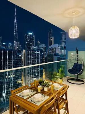 a dining room with a view of a city skyline at In the heart of Business Bay - Bills included in Dubai