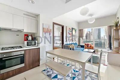 a kitchen and living room with a table and chairs at In the heart of Business Bay - Bills included in Dubai