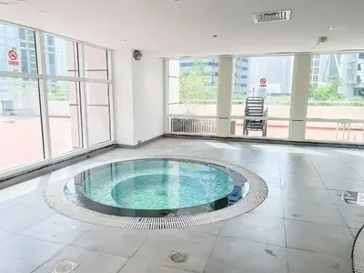 a large room with a pool in the middle of a building at Cosmos Living Dubai Arch Tower Pool, Gym & Balcony in Dubai