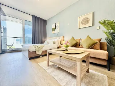 a living room with a couch and a table at Cosmos Living Dubai Arch Tower Pool, Gym & Balcony in Dubai