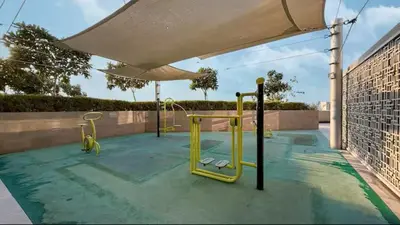 a playground with yellow equipment in a swimming pool at Vogue Creek Harbour The Grand Waterfront Living close to Downtown, Burj Khalifa and Dubai Mall, Two Bedroom Apartment with Balcony, Canal and Vibrant Community View, Access to all Amenities in Dubai