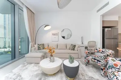 a living room with a couch and a table at Vogue Creek Harbour The Grand Waterfront Living close to Downtown, Burj Khalifa and Dubai Mall, Two Bedroom Apartment with Balcony, Canal and Vibrant Community View, Access to all Amenities in Dubai