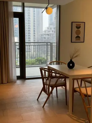 a dining room with a table and chairs and a large window at ROYAL APARTMENTS DUBAI in Dubai