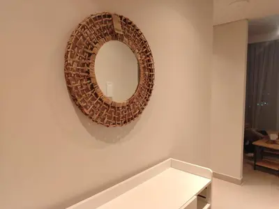 a mirror on the wall of a living room at ROYAL APARTMENTS DUBAI in Dubai