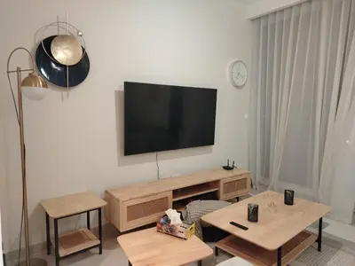 a living room with a flat screen tv on the wall at ROYAL APARTMENTS DUBAI in Dubai