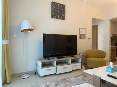a living room with a large flat screen tv at ROYAL APARTMENTS DUBAI in Dubai