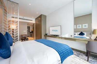 a bedroom with a king sized bed and a desk at ALiving Stylish Studio with Partial Burj & Canal Views- Prive , Business bay 713 in Dubai