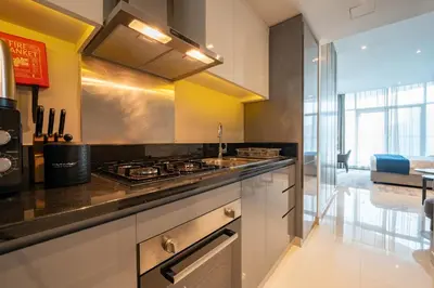 a kitchen with a stove and a counter top at ALiving Stylish Studio with Partial Burj & Canal Views- Prive , Business bay 713 in Dubai