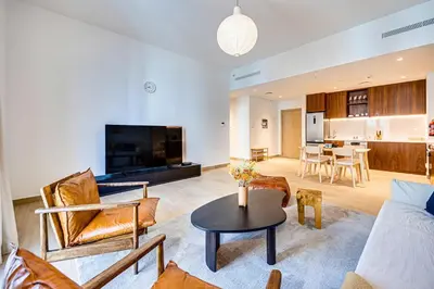 a living room with a couch and a table at Amazing 1BD sea view apartment in Port de La Mer in Dubai