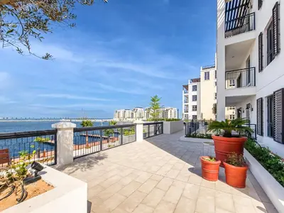 an apartment balcony with a view of the ocean at Amazing 1BD sea view apartment in Port de La Mer in Dubai