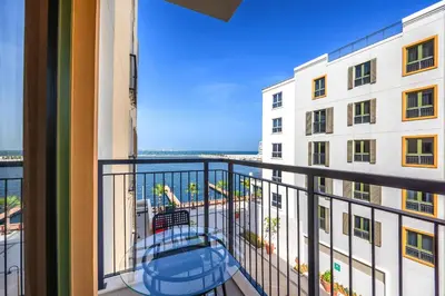 a balcony with a view of a building at Amazing 1BD sea view apartment in Port de La Mer in Dubai