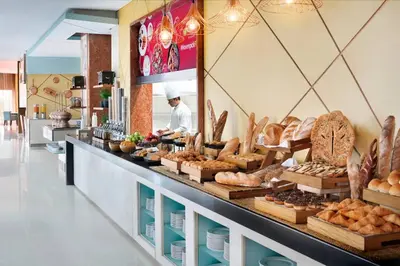 a bakery with a counter with bread and pastries at ModernLux - Luxury Duplex 1 BR in Movenpick Hotel JLT with Lake View in Dubai