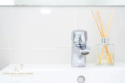 a bathroom sink with a faucet next to a sink at Marco Polo - Enjoy comfort and class near Burj Khalifa in Dubai