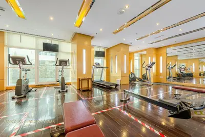 a gym with treadmills and a bowling alley at Marco Polo - Enjoy comfort and class near Burj Khalifa in Dubai