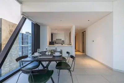 a kitchen and dining room with a table and chairs at 3BDR Apartment with Maid Room and Burj Khalifa View in Dubai