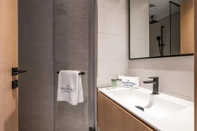 a bathroom with a sink and a mirror at 3BDR Apartment with Maid Room and Burj Khalifa View in Dubai