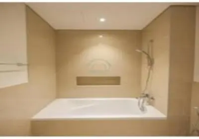 a bathroom with a shower and a white tub at Elegant Apartment With Balcony Amidst Vibrant Area in Dubai