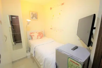 a small room with a bed and a flat screen tv at Roomy Dubai Hostel Small Rooms and Partitions at Marina in Dubai