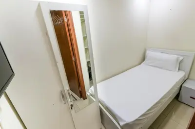 a small room with a mirror and a bed at Roomy Dubai Hostel Small Rooms and Partitions at Marina in Dubai
