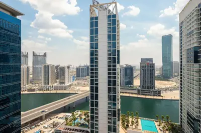 a view of a city skyline with a tall building at Frank Porter - Marquise Square Tower in Dubai